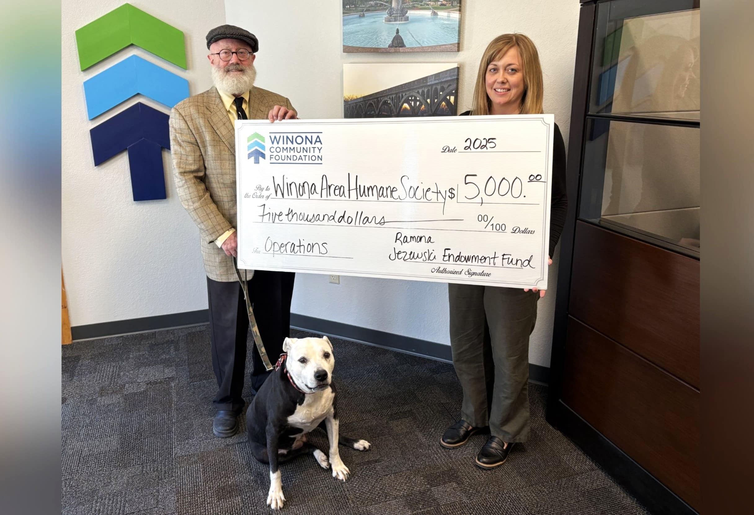Rich McCleur and Mandi Olson pose with $5,000 directed to the Winona Humane Society